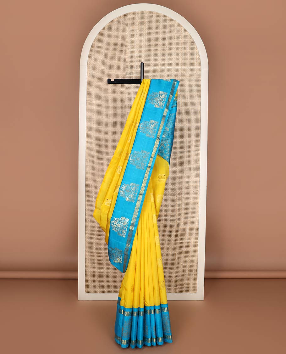 Sandal Kanchipuram Silk Saree, Sparsely Woven with Zari Buttas on Its Body, Complemented by a Contrast One-Sided Korvai Border of Salngai, Banaras, Muthu, and Chakram Designs, Pallu Steeped with Chakram Designs, and Comes Without a Blouse
