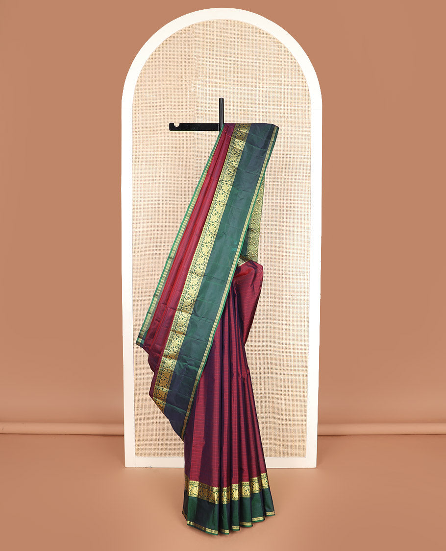Maroon striped Kanchipuram silk saree, contrast rettai pettu border of manga, muthu, banaras, and kodi visiry designs, and zari striped pallu