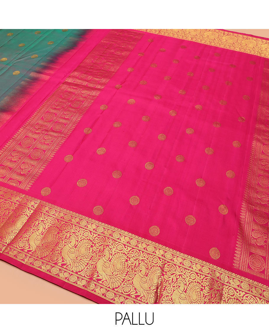 Green dual-tone chakram buttas Kanchipuram silk saree, contrast border of mayil chakram designs, and pallu of chakram buttas