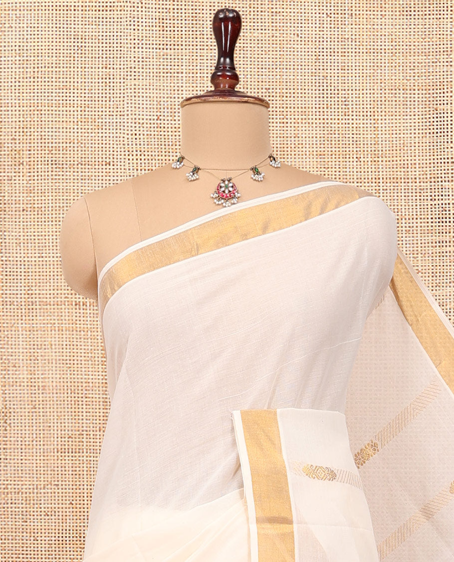 Cream Kerala Cotton Saree, Adorned with Zari Stripes All Over Its Body, a Subtle Bavanji Border, Pallu Features Intricate Designs, and Is Paired with a Matching Blouse