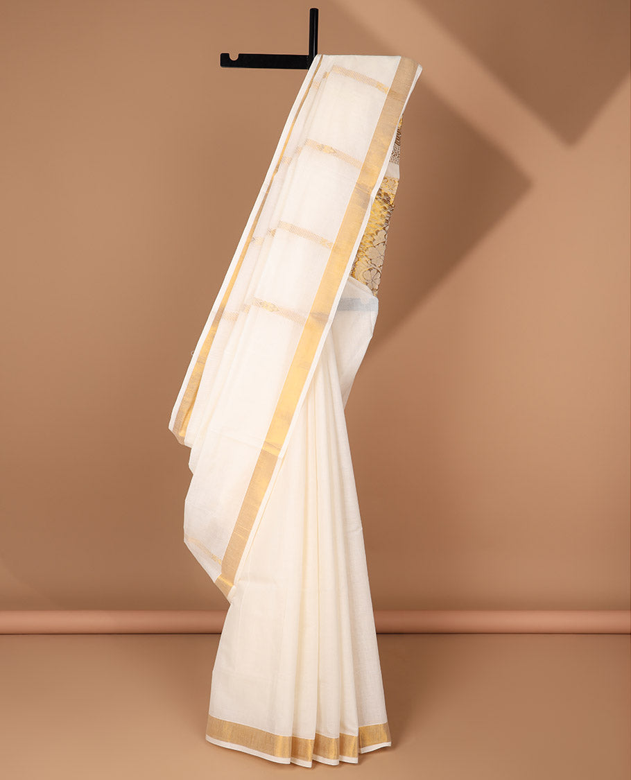 Cream kerala saree with zari stripes, zari border & pallu of floral designs