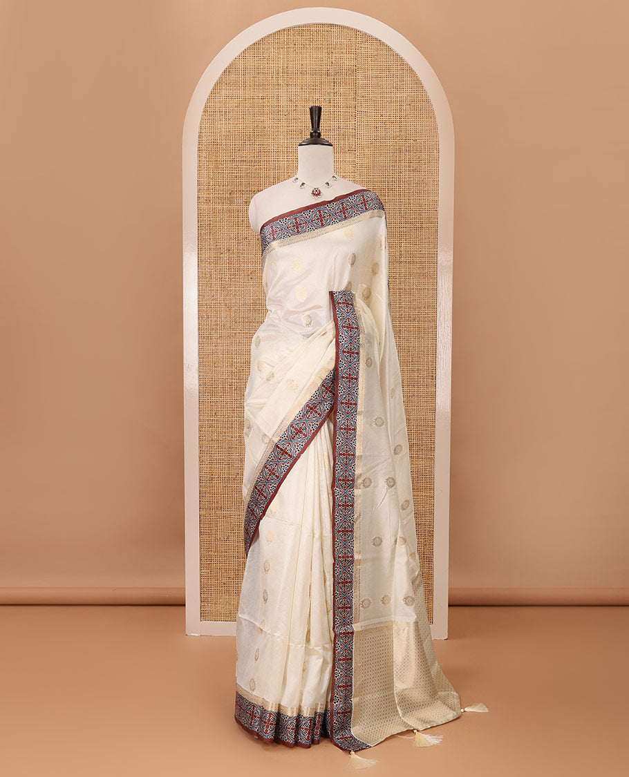 Cream gold zari buttas semi-organza saree, contrast zari & Ajrakh printed brown border, zari weaving pallu & Ajrakh printed blouse
