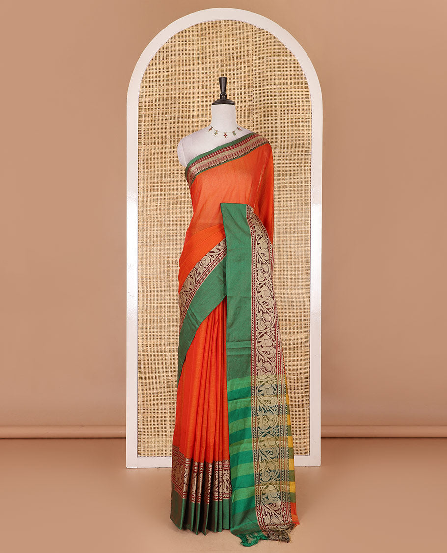 Orange plain mercerised cotton saree, contrast traditional border of peacock, and elephant motifs, striped pallu, and a matching blouse