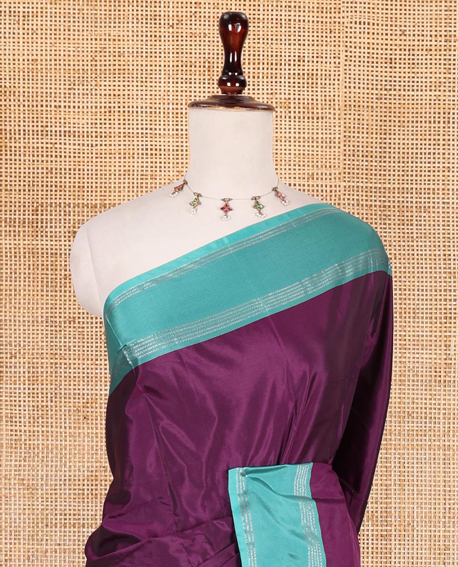 Dark purple plain semi-soft silk saree, contrast zari striped border, striped pallu, and matching blouse