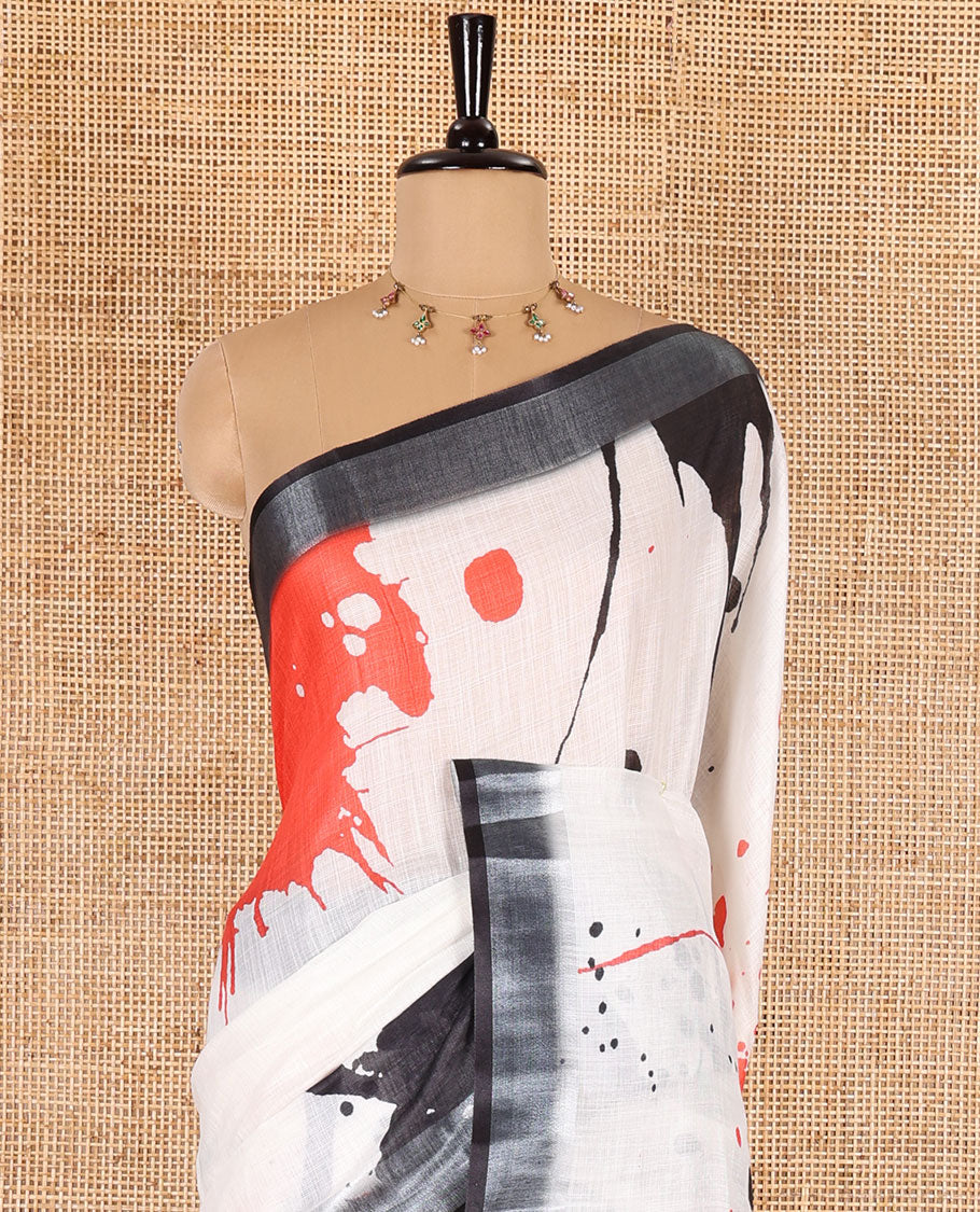 White colorful paint splashes printed linen cotton saree, contrast bavanji border, paint splashes printed pallu, and a contrast ajrakh printed blouse