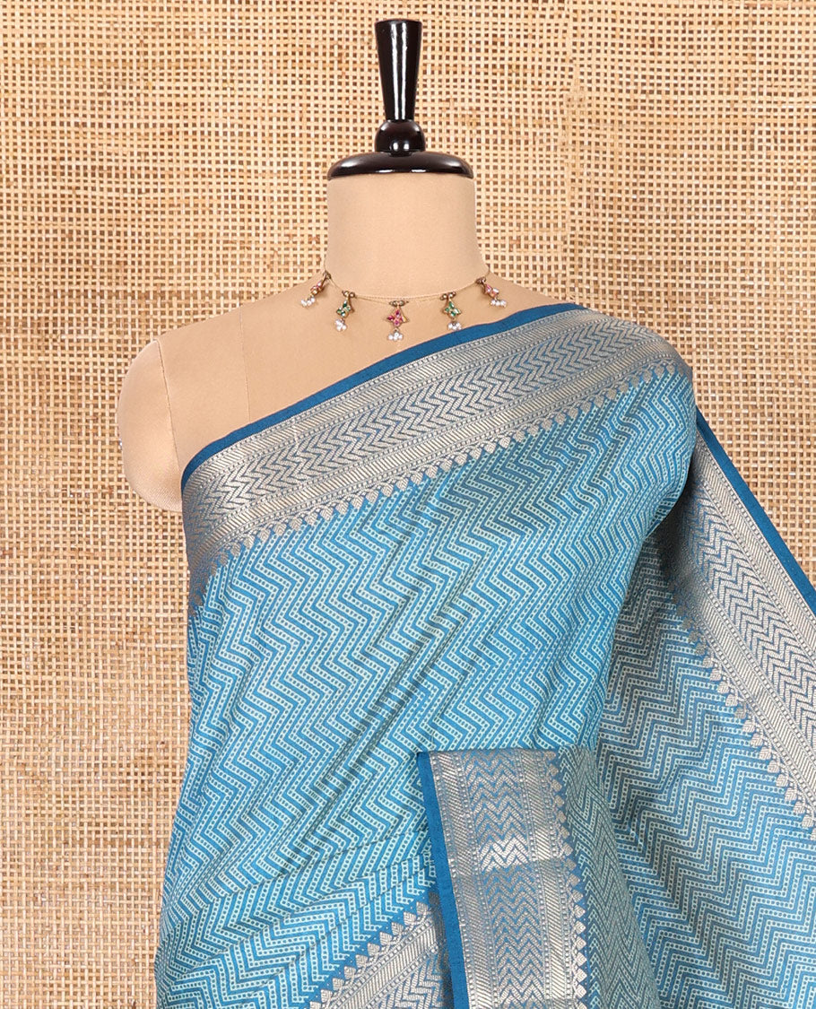 Blue Semi-Tussar Saree Accentuated with Zig-Zag Strips Prints, Featuring a Self-border with Traditional Motifs, a Zari-Striped Pallu, Paired with a Matching Blouse