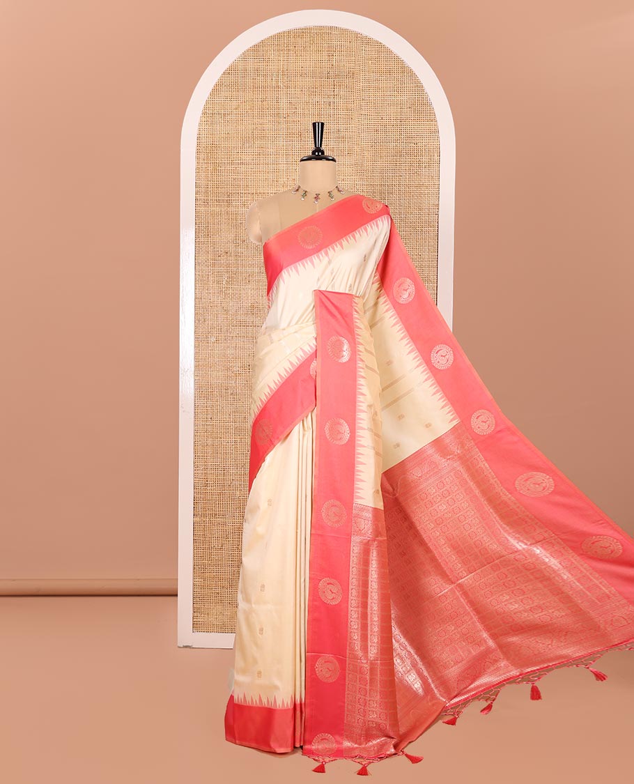 Cream Elite Soft Silk Saree, Beautified with Zari Buttas and Zari Stripes All Over Its Body, Complemented by a Contrast Temple Border of Round Peacock Designs, Rich Pallu of Peacock Chakram Butta Enclosed Checks, and Paired with a Contrast Blouse