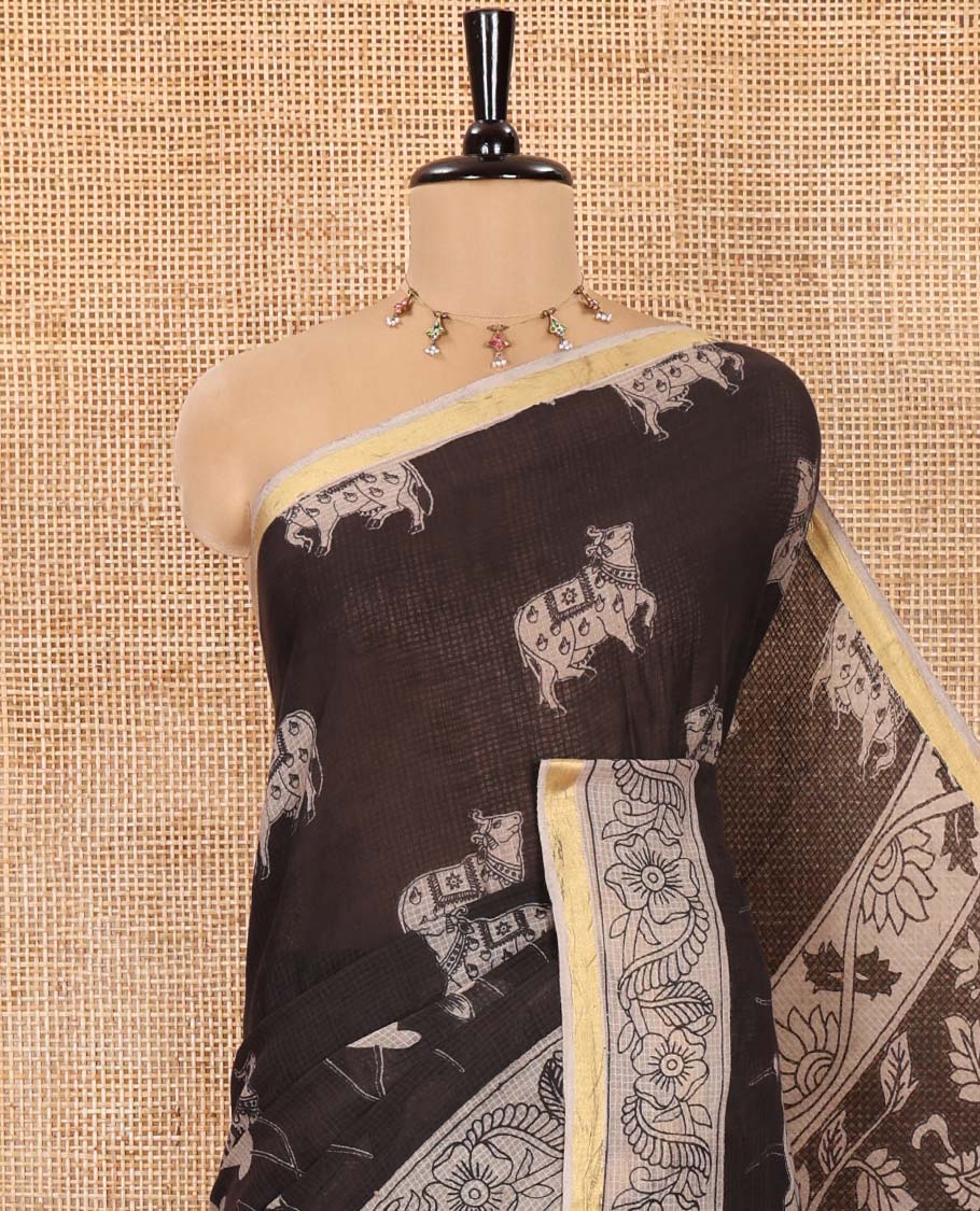Black Kota Cotton Saree, Artfully Printed with Pichwai Cow Motifs on Its Body, Complemented by Contrast Border of Floral Creeper Print, Pallu Pictures Kalamkari Peacock and Floral Designs, and Paired with a Contrast Floral Printed Blouse