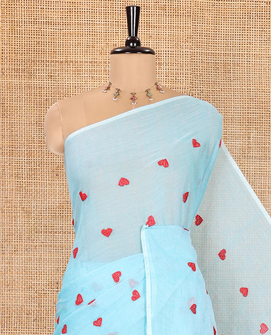 Borderless Sky Blue Khadi Mul Cotton Saree, Artfully Designed with Heart Motifs Embroidery Across Its Body, Pallu mirrors the Same Design, and Paired with a Matching Blouse