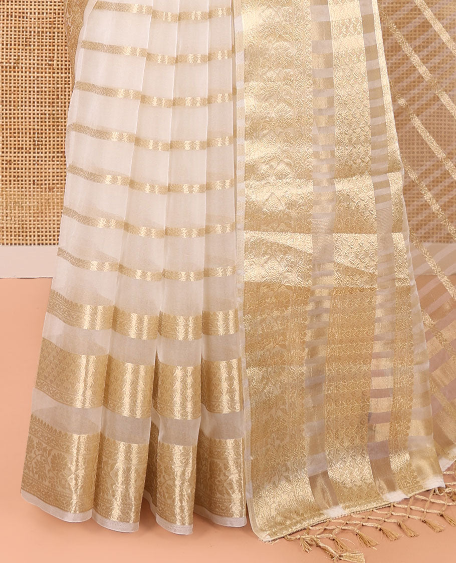Cream Semi-Organza Saree, Gleamed Up with Zari Stripes All Over Its Body, Highlighted by a Traditional Zari Design Border, Gleaming Zari Striped Pallu, and Paired with a Matching Blouse