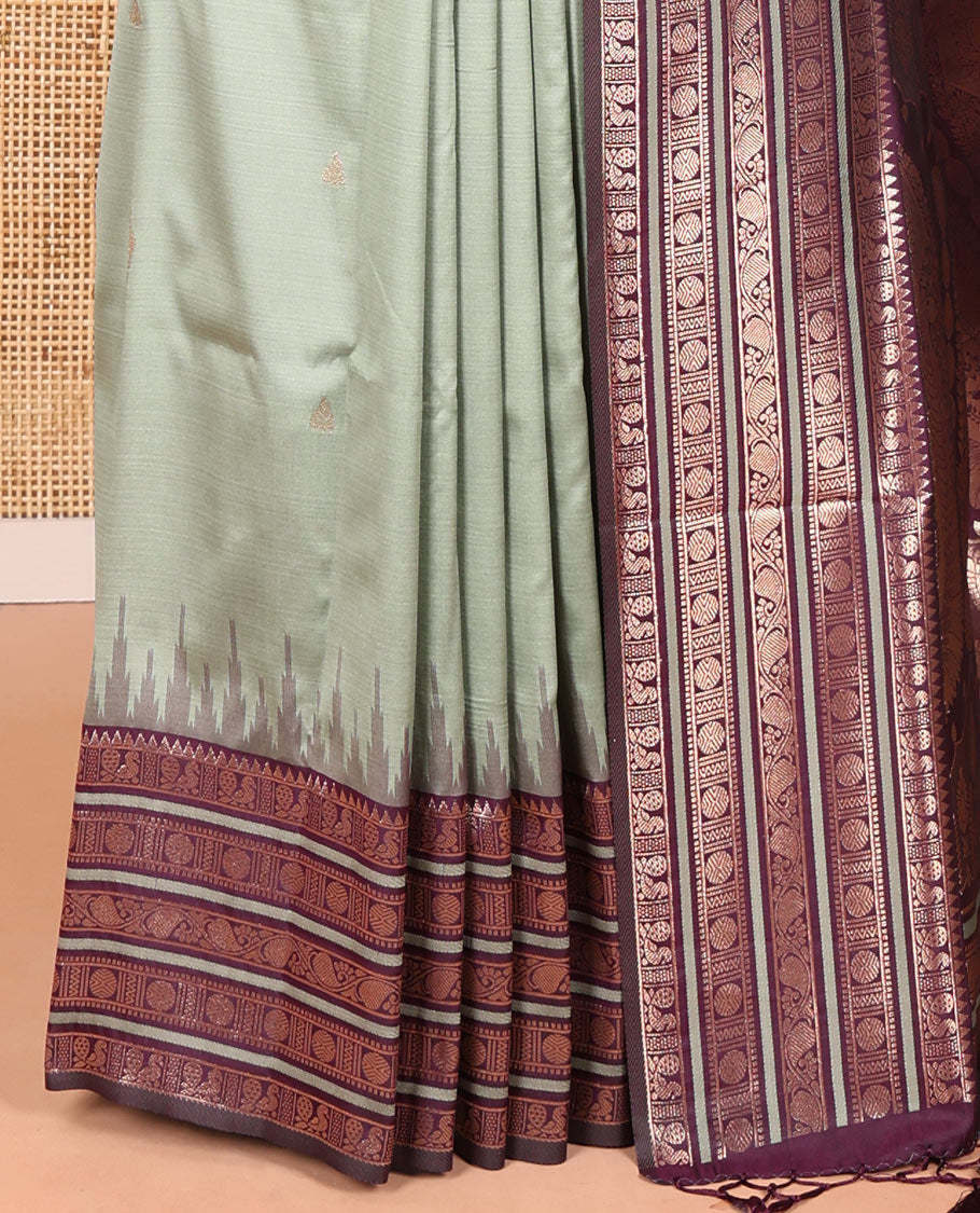 Pista Green Elite Soft Silk Saree, Enriched with Zari Buttas All Over Its Body, Complemented by Contrast Temple Traditional Zari Border of Peacock-Rudraksham Motifs, Intricately Zari Woven Pallu and Paired with a Contrast Blouse