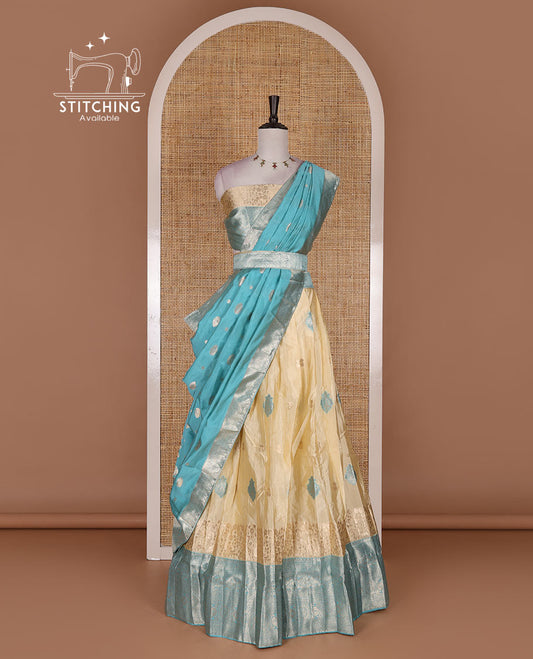 Cream taffeta silk half saree, meena buttas skirt, contrast blue traditional zari border, matching blouse, and zari woven dhavani