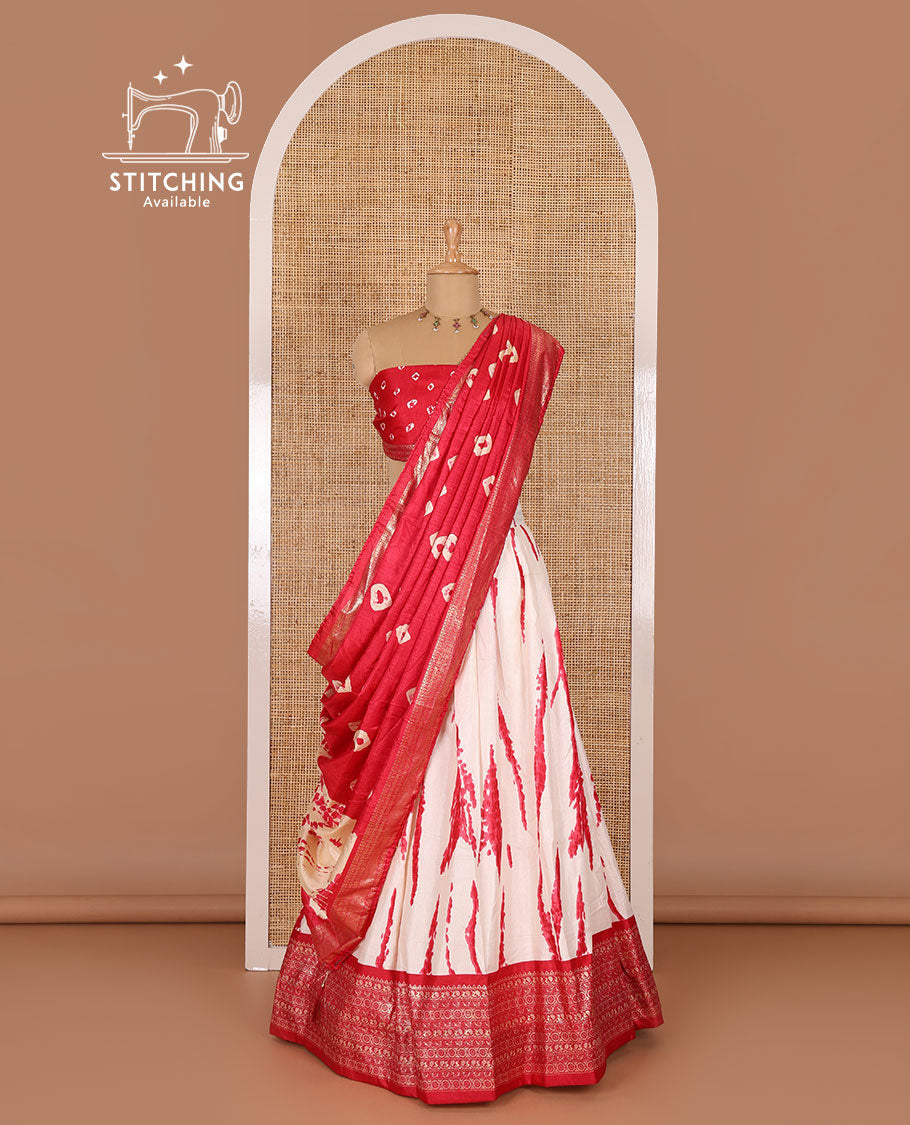Cream and pink semi-tussar half-saree, shibori printed with contrast geometric patterned bordered skirt, bandhani printed blouse, and bandhani printed dhavani