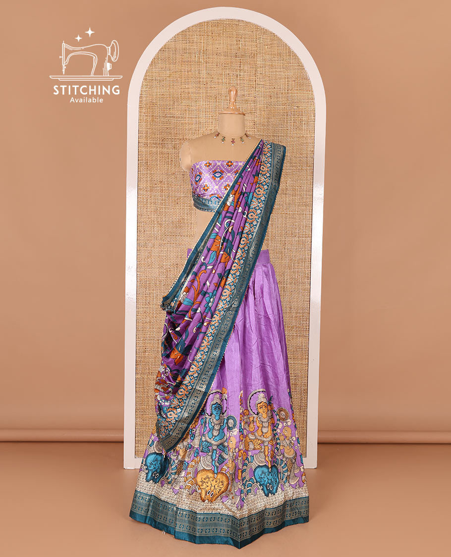 Purple semi-tussar half-saree, kalamkari human figurines printed with a contrast geometric bordered skirt, patola printed blouse, and kalamkari floral vine printed dhavani