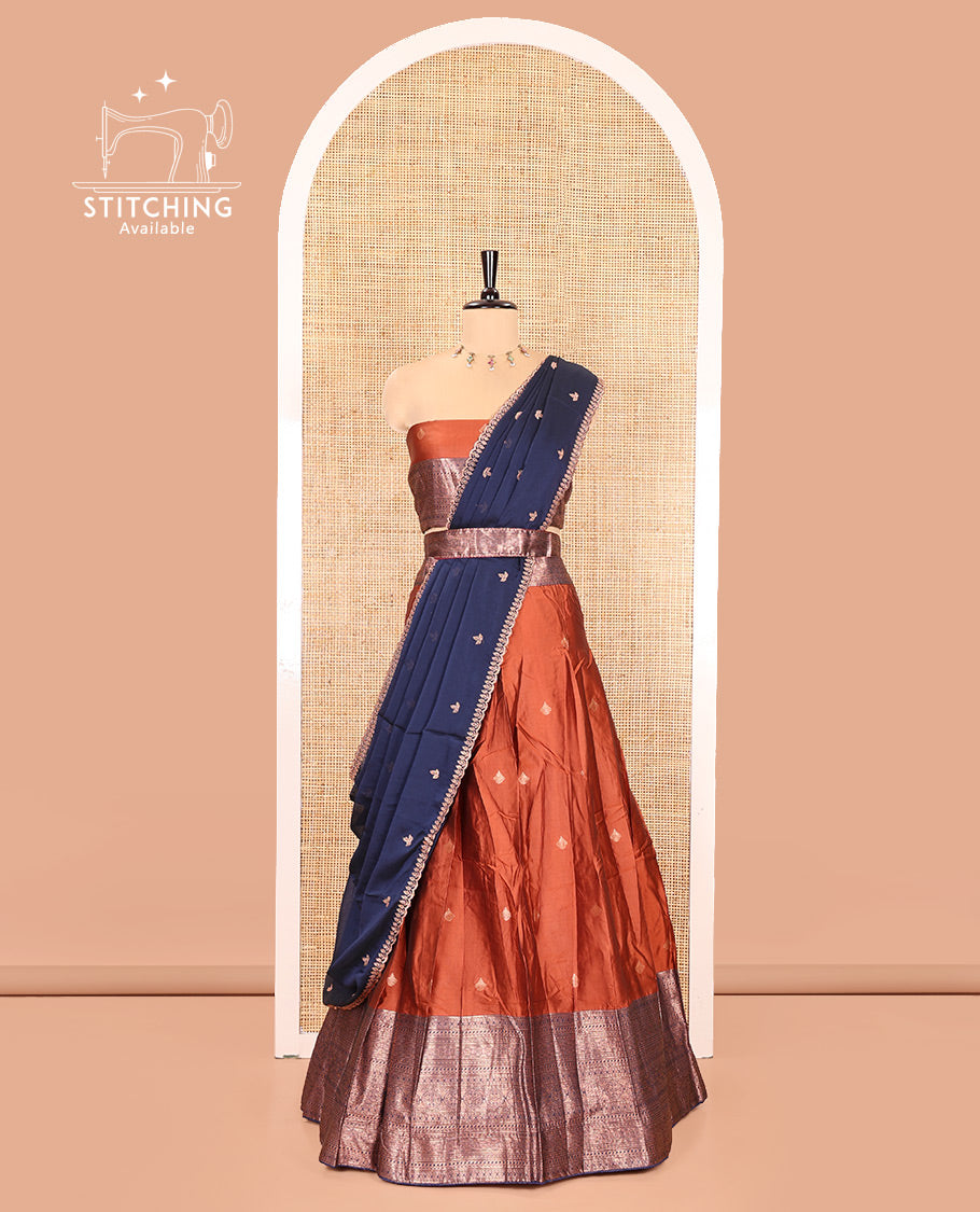Rust and Navy Blue Semi-Banarasi Half-Saree, Embellished with Zari Buttas on Its Skirt, Complemented by a Contrast Traditional Zari Designs Woven Border, Paired with a Matching Blouse, and a Contrast Satin Georgette Embroidered Scallop Dhavani