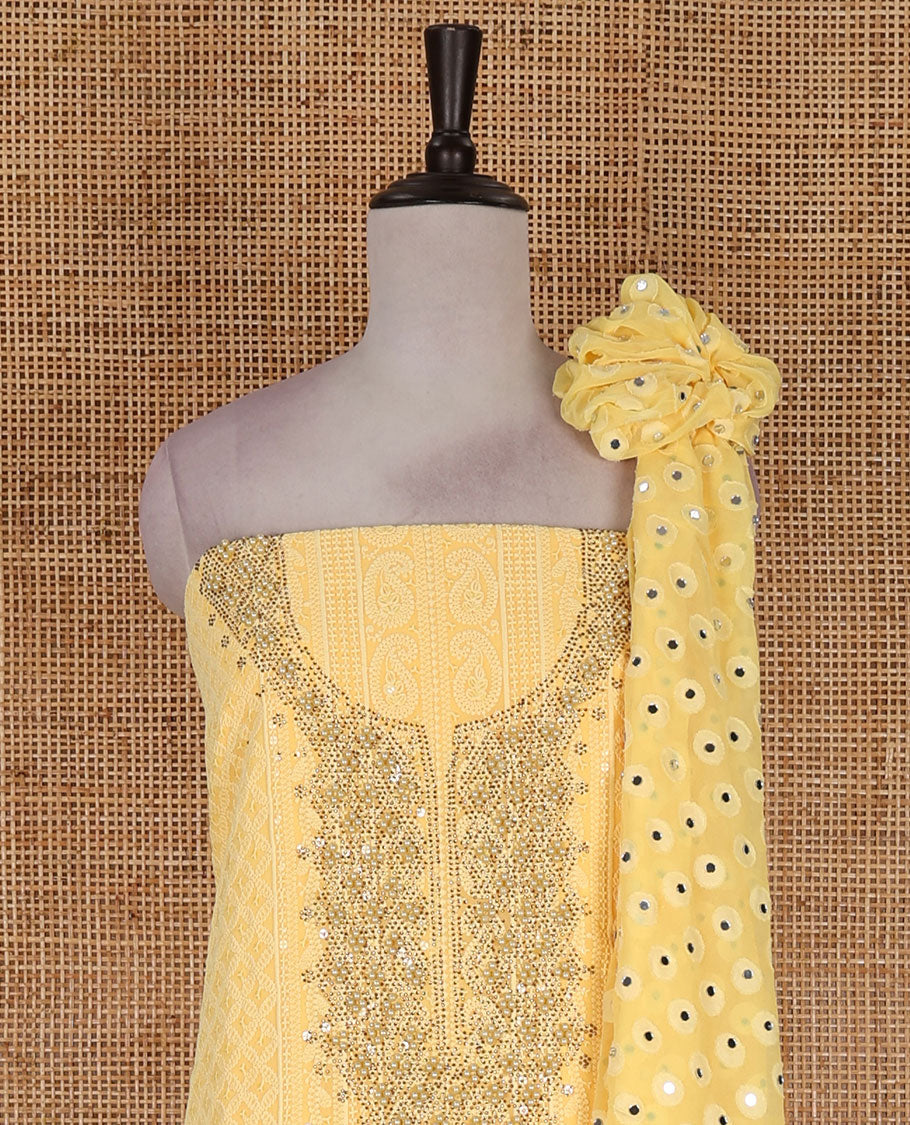 Yellow material churidar set, stone work with Schiffli style embroidered georgette top, American Crape bottom, and polka dotted printed mirror work dupatta
