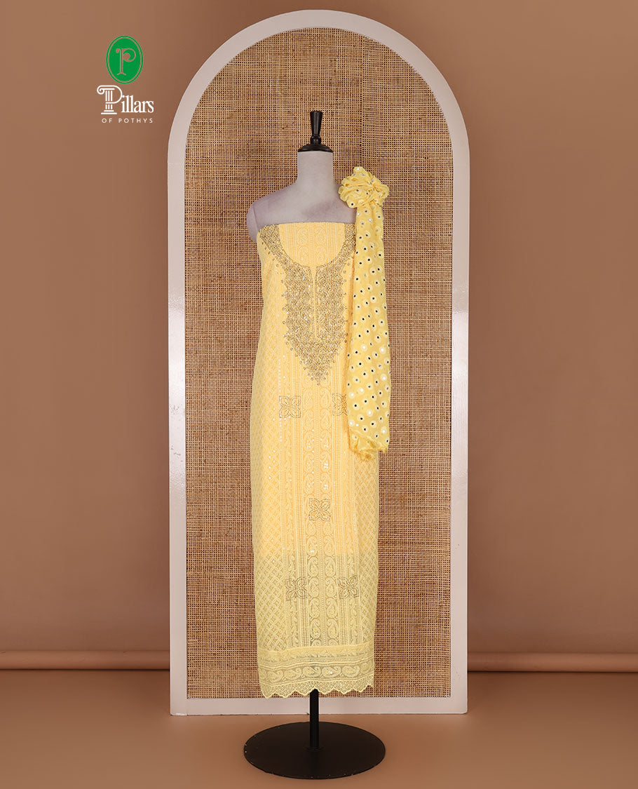 Yellow material churidar set, stone work with Schiffli style embroidered georgette top, American Crape bottom, and polka dotted printed mirror work dupatta