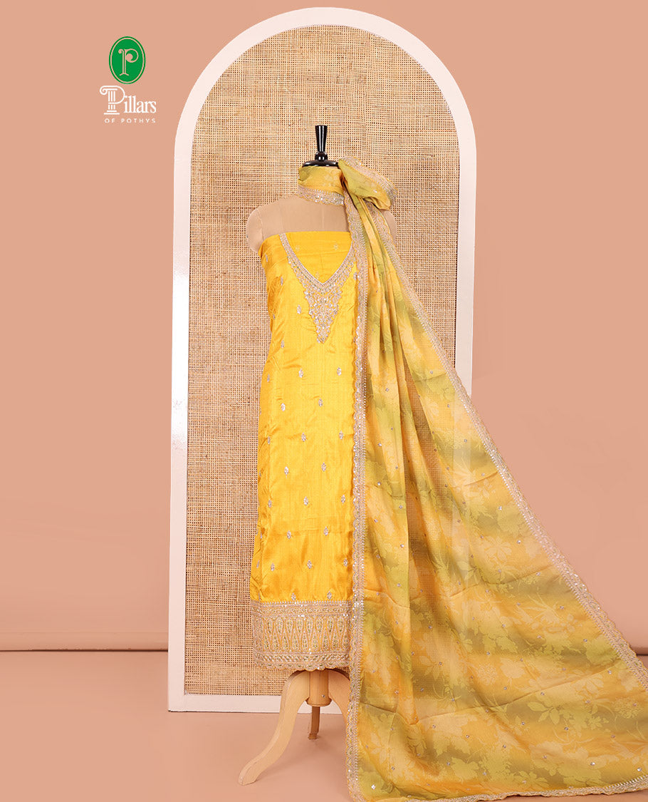 Yellow Material Chudidar Set Beautified with Intricately Embroidered Muga Silk Top, Subtly Made Plain Santoon Bottom, and a Bemberg Chiffon Dupatta Featuring Floral Printed, and Embroidery