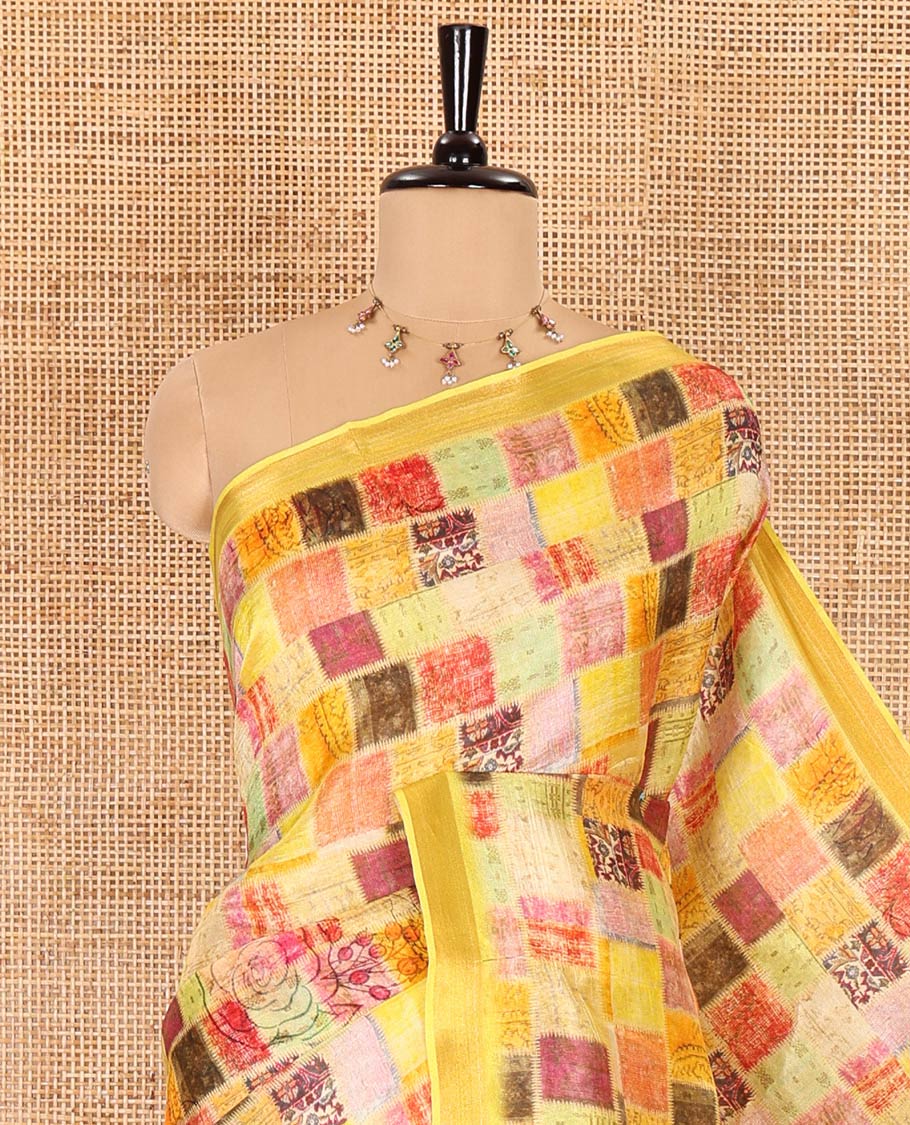 Yellow-base unique motifs enclosed colorful checks printed banana pith saree, zari striped pallu, and a matching blouse