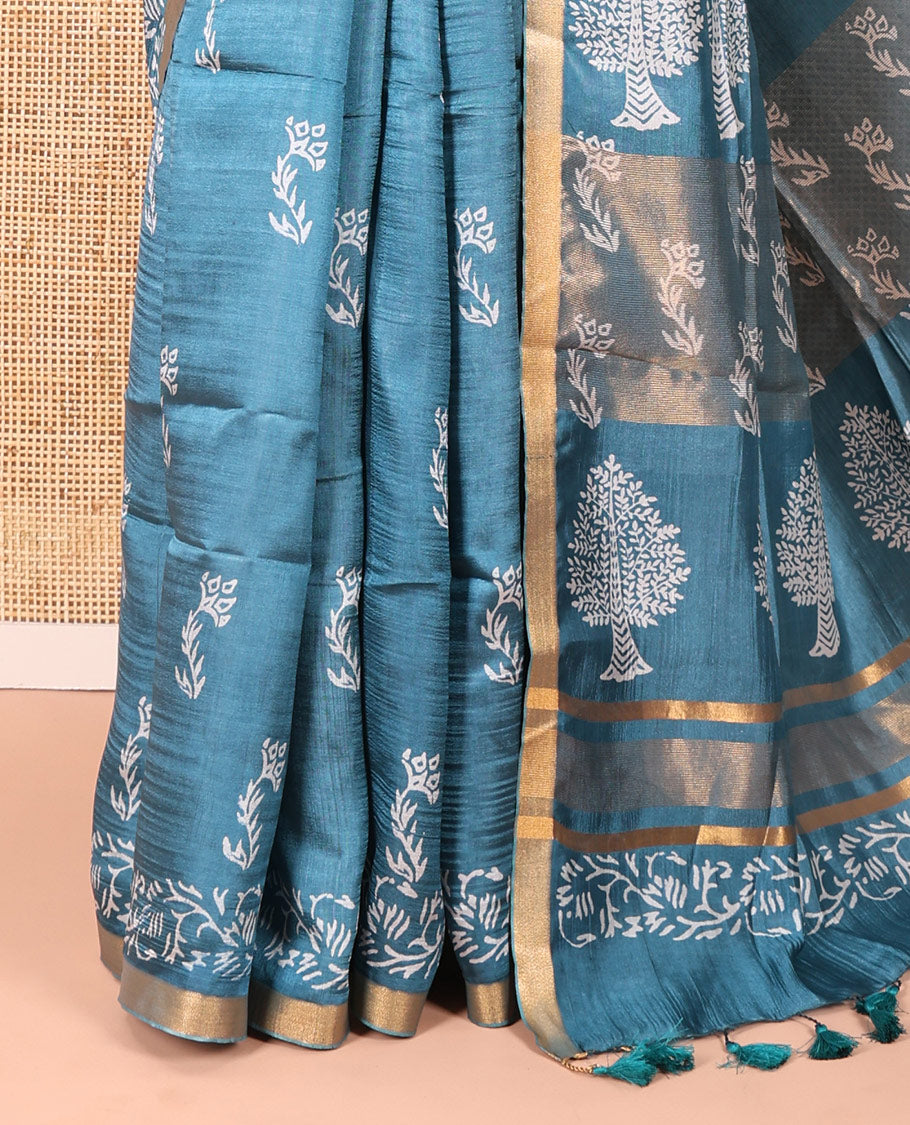 Blue Banana Pith Saree Graced with Floral Motifs Discharge Print All Over Its Body, Zari Bavanji Border, Pallu Subtly Woven in Floral-Tree Print and Zari Weave, and Paired with a Matching Blouse