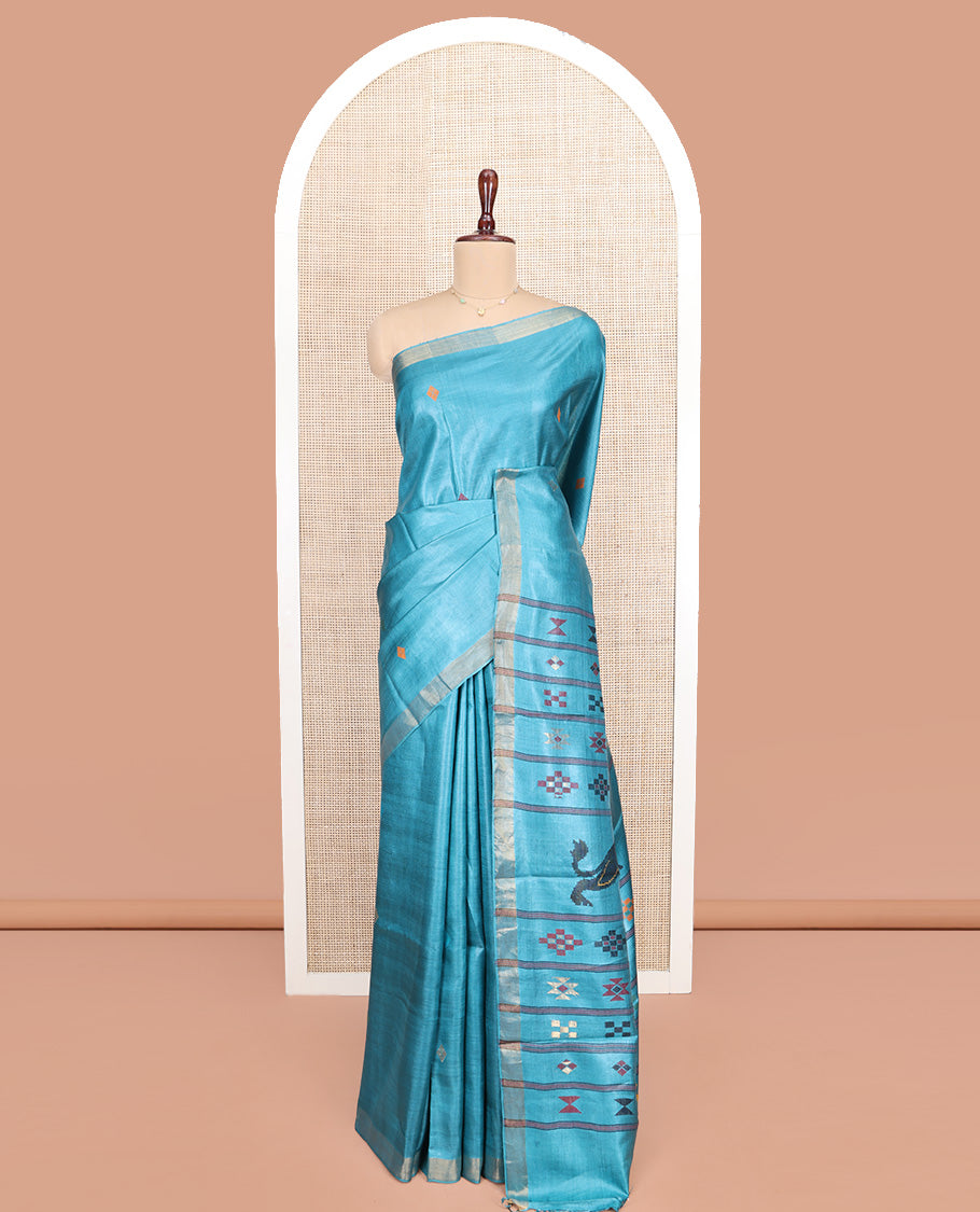 Blue Tussar Silk Saree, Subtly Woven with Multi-Color Diamond Buttas All Over Its Body, Subtle Bavanji Border, Pallu Depicts Animal and Geometric Designs, and Paired with a Matching Blouse