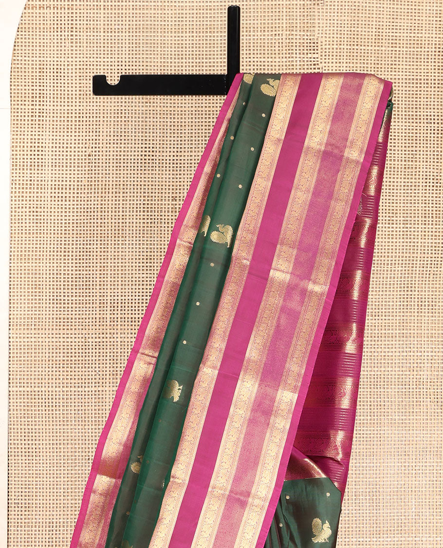 Green Vasundhara Lite Silk Mix Saree, Graced with Mayil Buttas All Over Its Body, Complemented by a Contrast Border of Neli, Muthu, and Chakram Designs, Pallu Steeped with Traditional Designs, and Paired with a Contrast Blouse