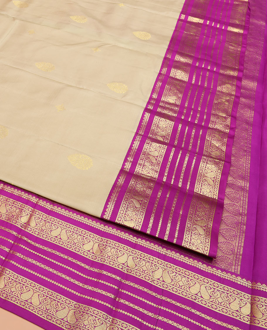 Sandal Vasundhara Silk Saree Adorned with Zari Buttas, Complemented by a Contrast Varisai Pettu Border of Neli, Diamond, and Manga Designs, Pallu Gleamed Up with Jaal Designs, and Paired with a Contrast Zari-Bordered Blouse