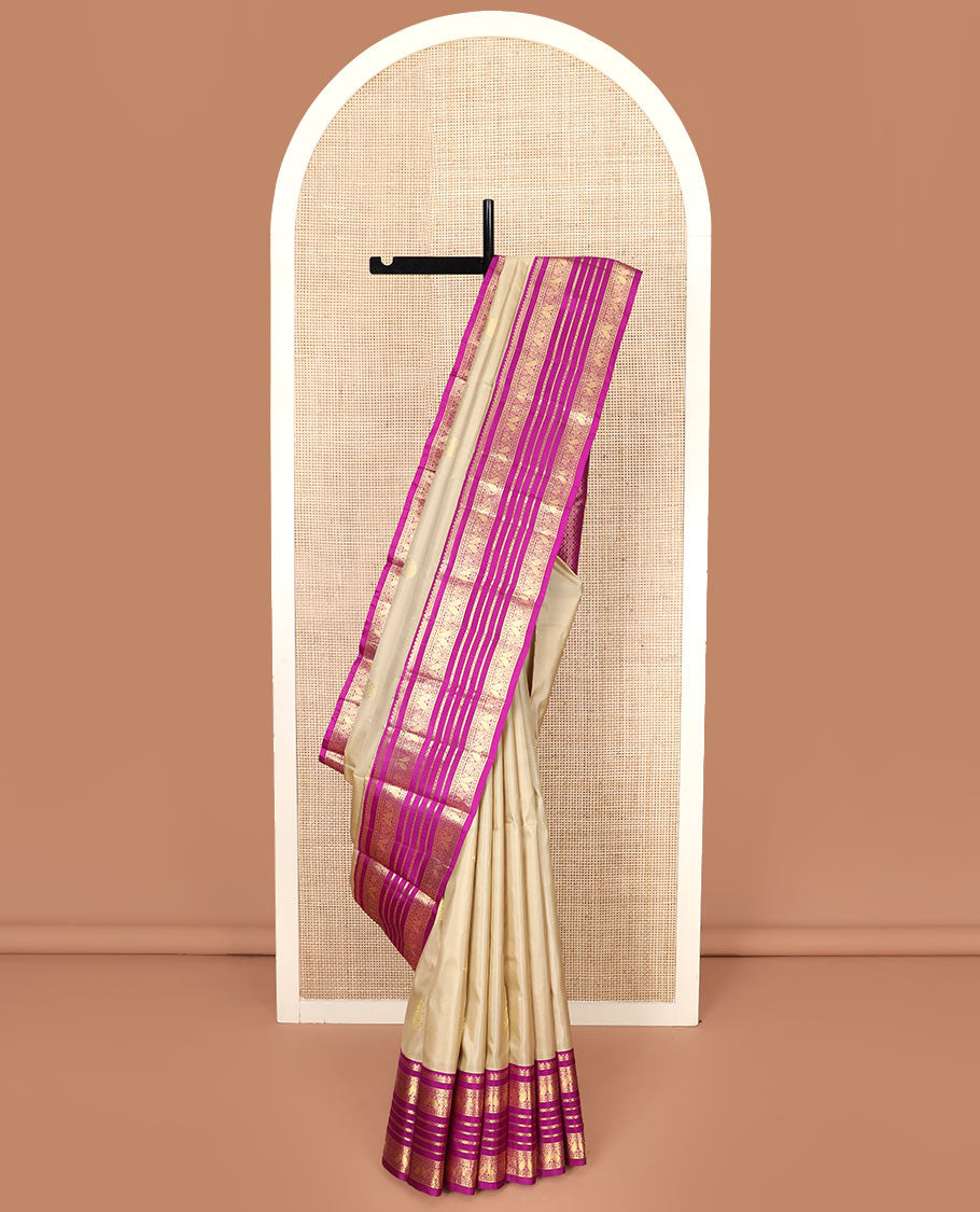 Sandal Vasundhara Silk Saree Adorned with Zari Buttas, Complemented by a Contrast Varisai Pettu Border of Neli, Diamond, and Manga Designs, Pallu Gleamed Up with Jaal Designs, and Paired with a Contrast Zari-Bordered Blouse