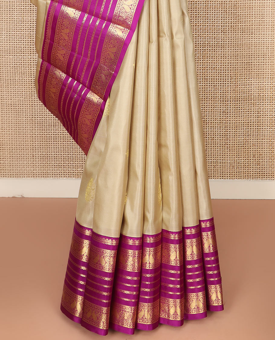 Sandal Vasundhara Silk Saree Adorned with Zari Buttas, Complemented by a Contrast Varisai Pettu Border of Neli, Diamond, and Manga Designs, Pallu Gleamed Up with Jaal Designs, and Paired with a Contrast Zari-Bordered Blouse