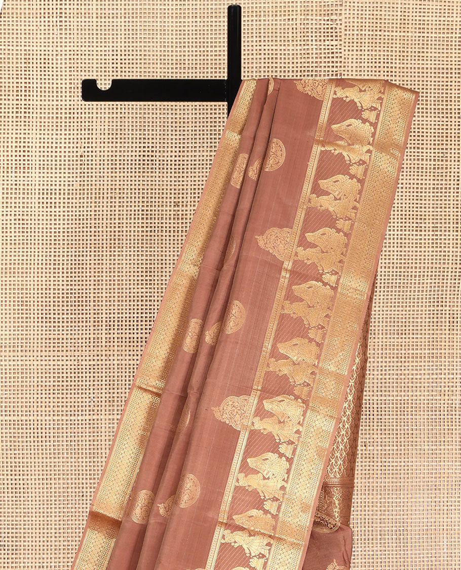 Pinkish Brown Vasundhara Silk Saree, Elevated with Zari Buttas All Over Its Body, Highlighted by Zari Border of Rekku, Muthu, Vangi, and Bride-Groom Suyamvaram Designs, Pallu of Zari Designs, and Paired with a Matching Blouse