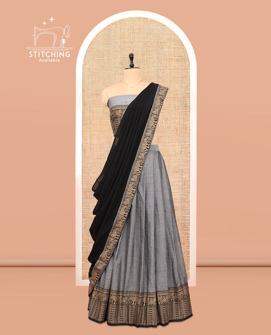 Grey Cotton Half-Saree Features Plain Skirt, a Contrast Traditional Thread Border, a Matching Blouse, and a Contrast Dhavani