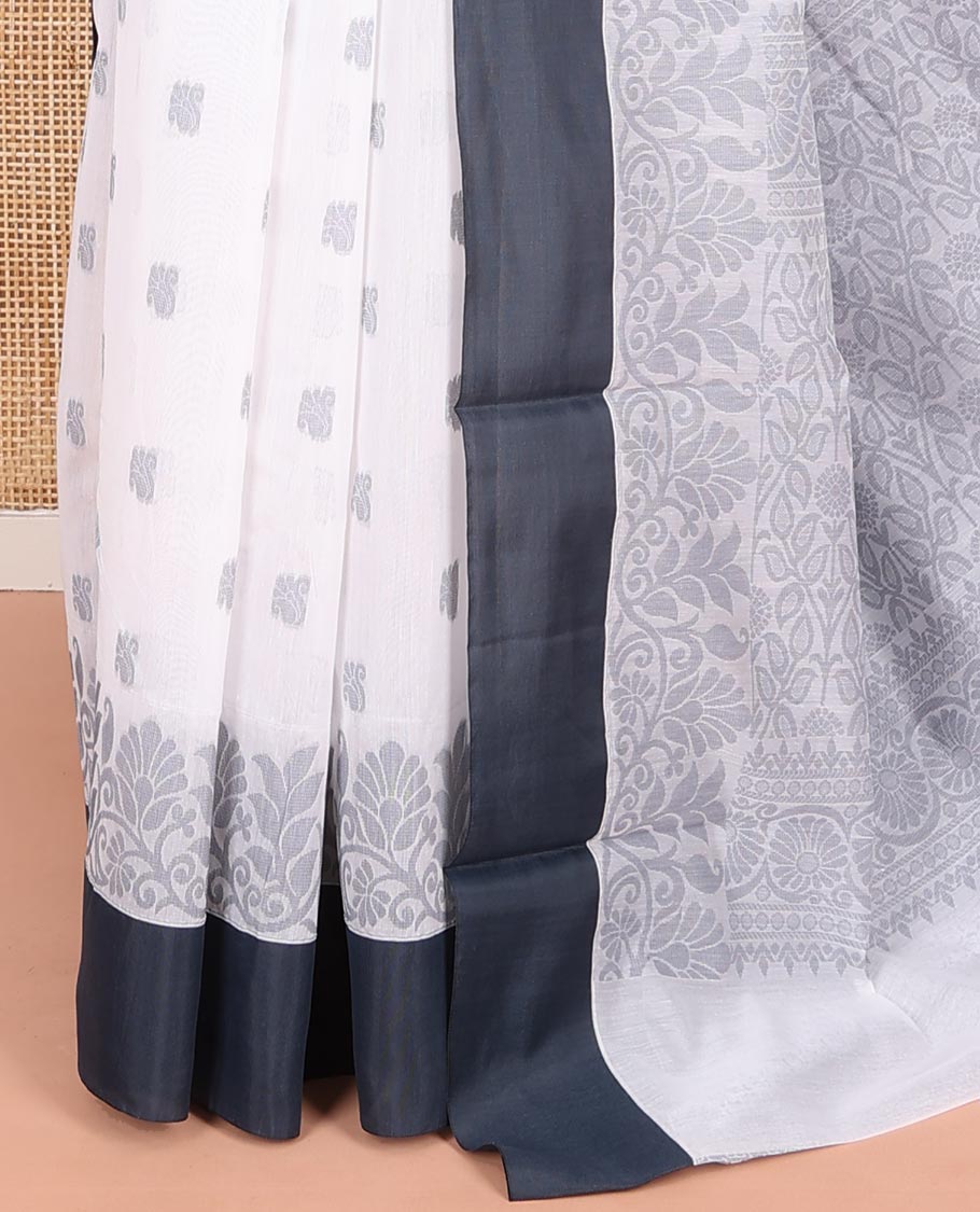 White Semi-Silk Cotton Saree, Sparsely Woven with Buttas and Floral Designs All Over Its Body, Complemented by Contrast Border, Sparsely Woven Pallu of Floral Jaal Designs, and Paired with a Matching Blouse