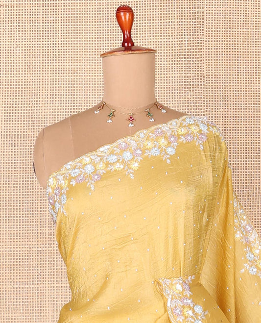 Yellow designer saree with stone embroidery throughout the body and pallu, scallop floral embroidery border