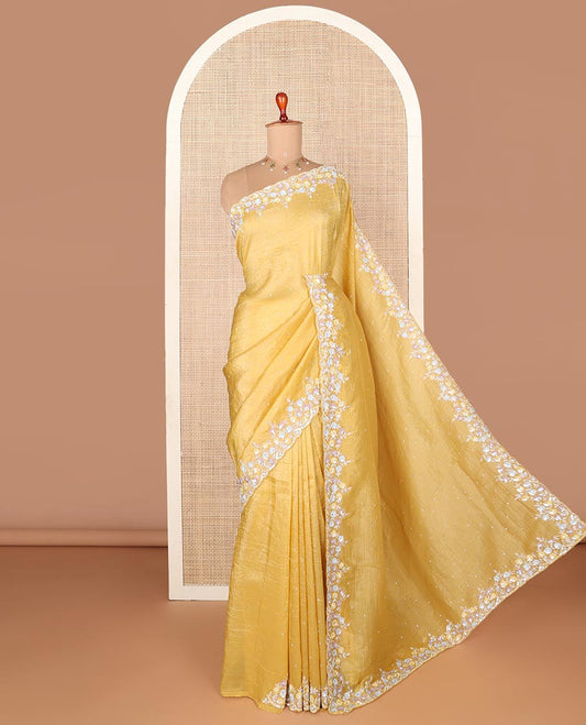 Yellow designer saree with stone embroidery throughout the body and pallu, scallop floral embroidery border