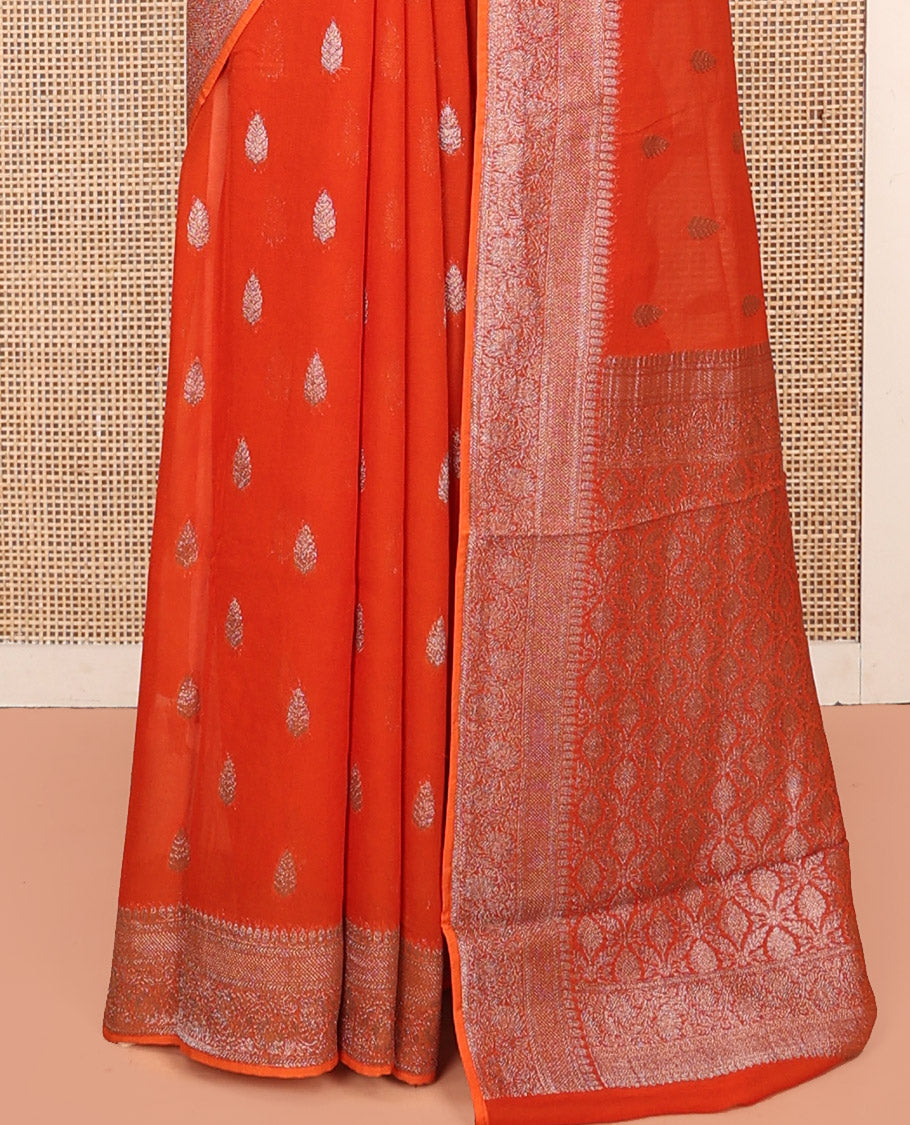 Orange Georgette Saree, Steeped with Buttas, Highlighted by a Traditional Floral Creeper Border, Intricately Designed Pallu, and a Matching Blouse