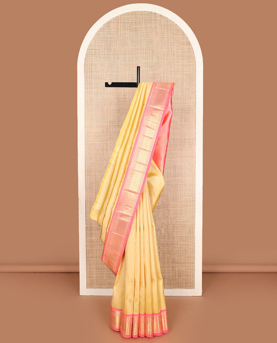 Yellow zari buttas Kanchipuram silk saree, contrast one-sided border of paneer sombu, banaras, muthu, and jaal designs, and zari design pallu