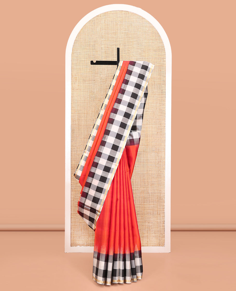 Orange Plain Mayuri Soft Silk Saree, Complemented by a Contrast Black-White Chess-Style Checked Border, Chess-Style Checked Pallu, and Paired with a Contrast Blouse