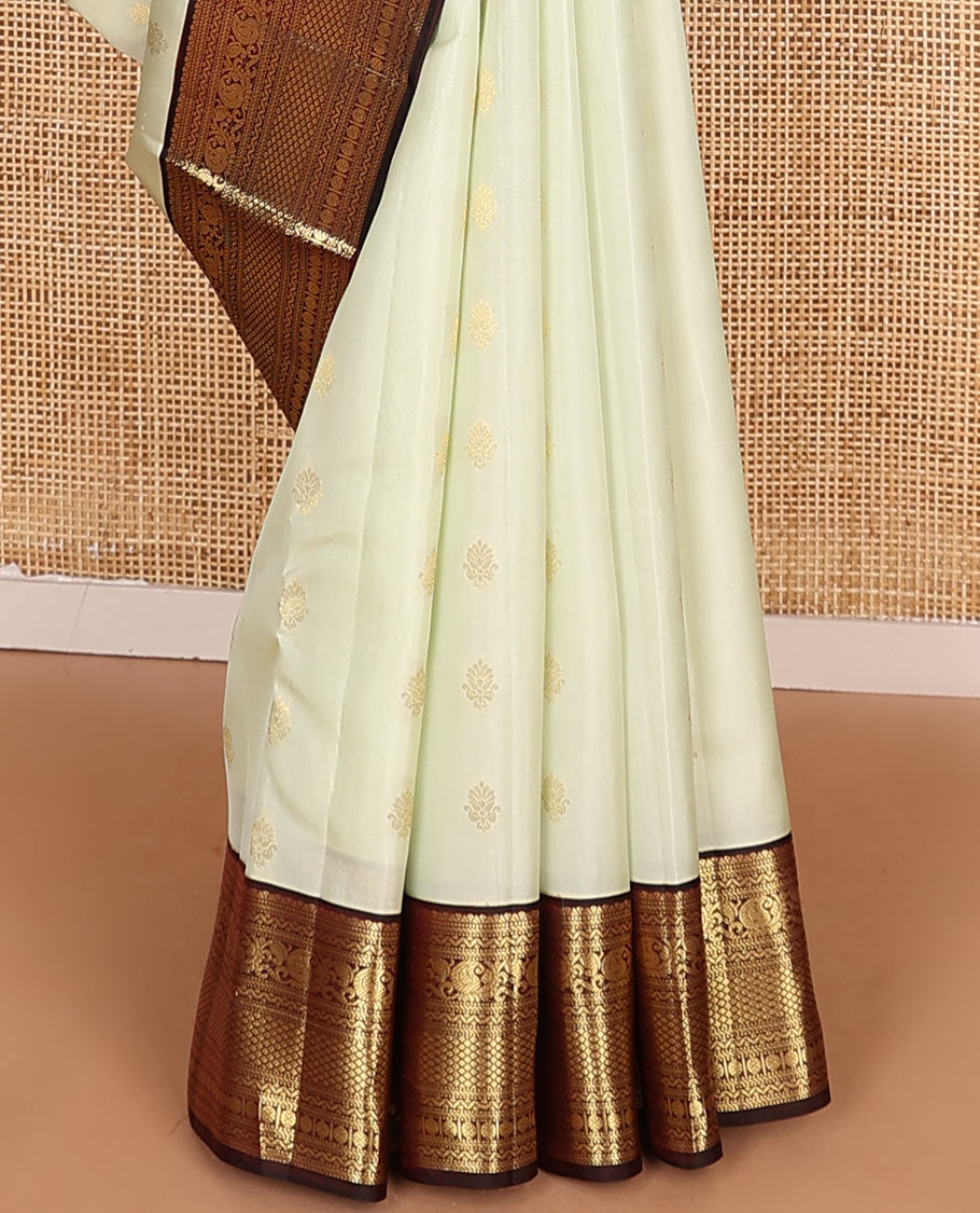 Enthralling Cream Vasundhara Lite-Silk Mix Saree Adorned with Zari Buttas, Complemented with a Contrast Border Featuring Muthu, Banaras, Neli, Manga, Mayil Kann, and Rudraksham Designs, Jaal Pallu, and a Contrast Blouse