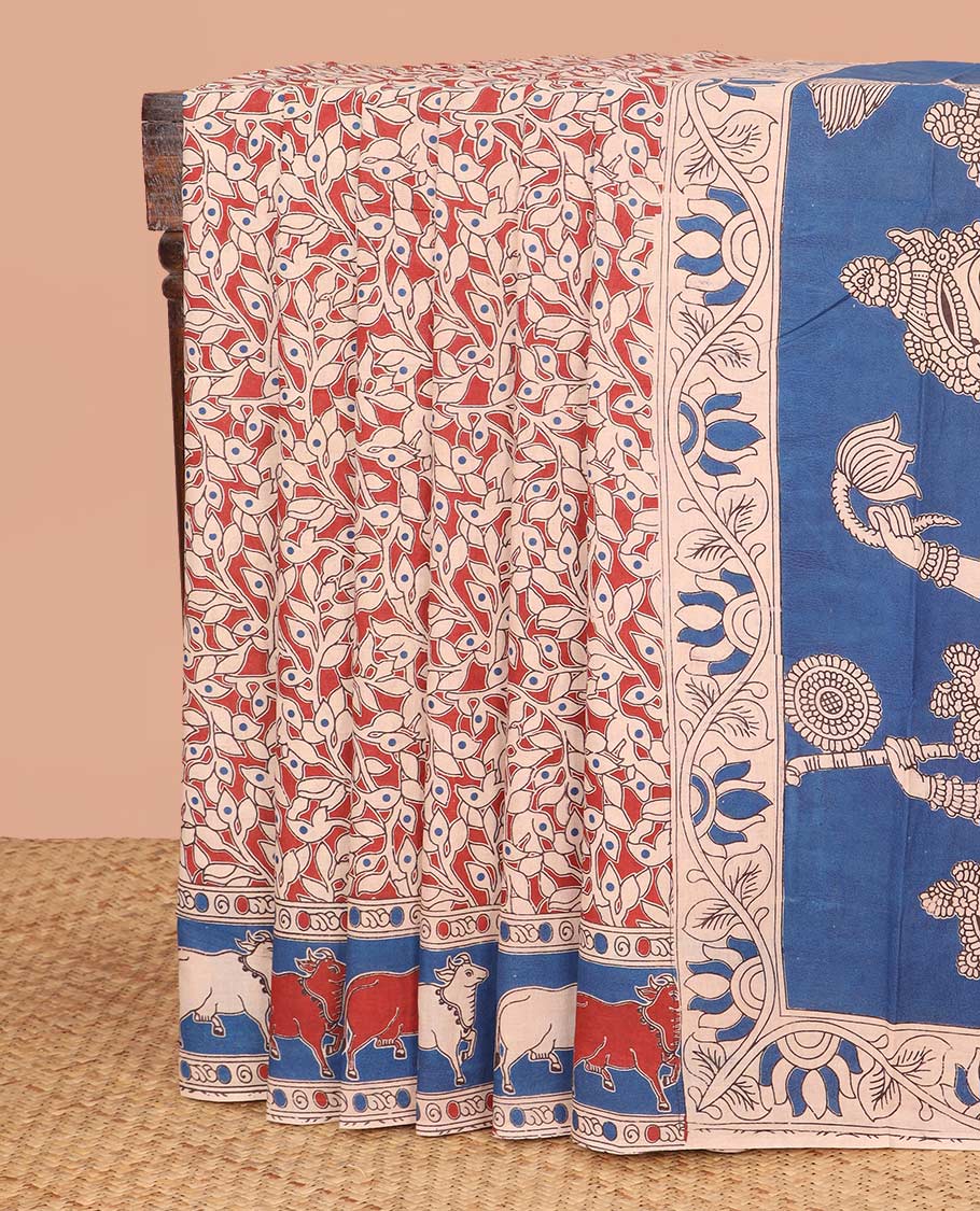Red Machine-Printed Kalamkari Cotton Saree Features Floral Vine Print on Its Body, Complemented by Contrast Pichwai Cow Printed Border, Pallu Depicts Lord Radha Krishnan Motifs, and Paired with a Printed Blouse