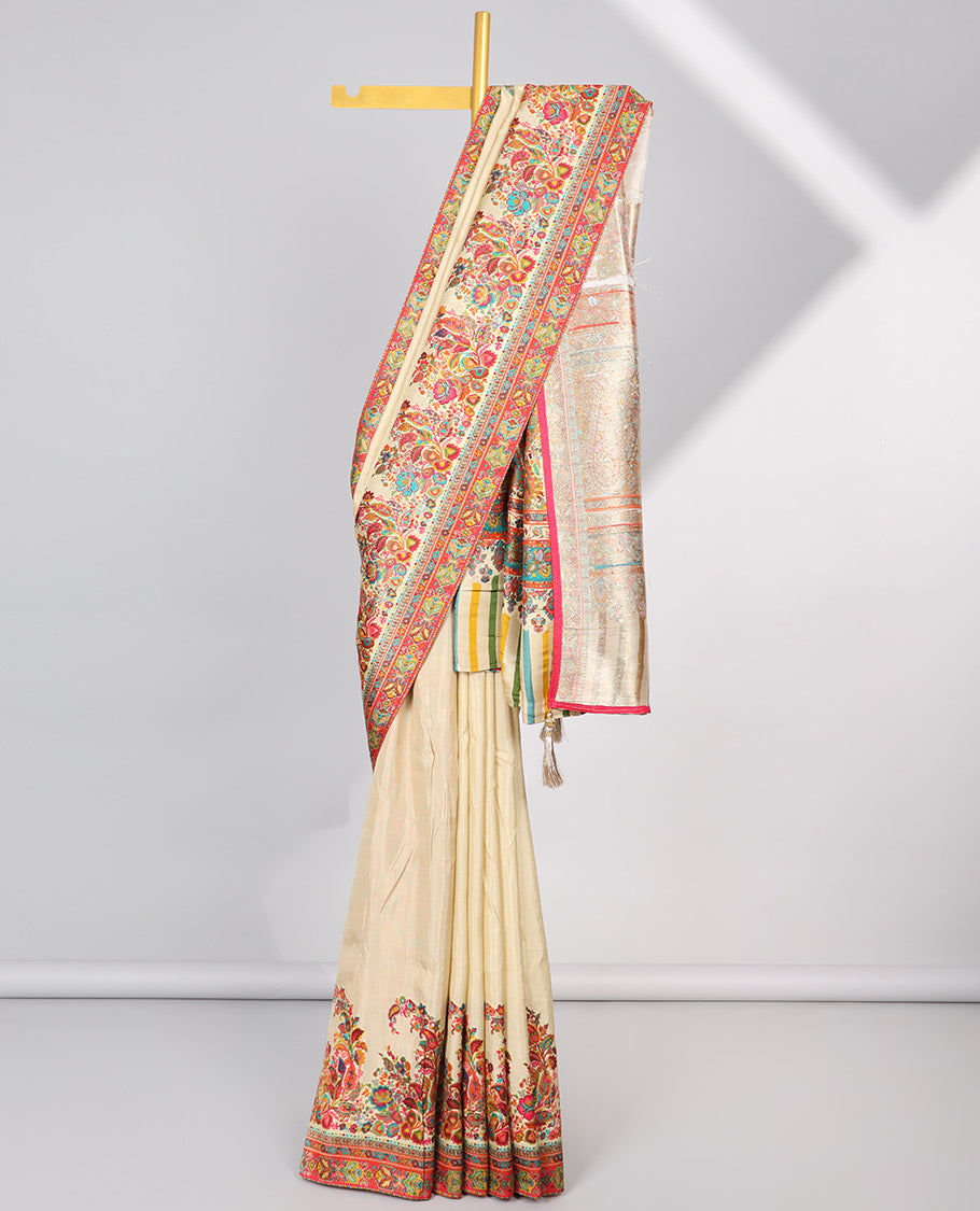 Cream semi-banaras dola silk saree with contrast floral motif border & paisley motifs pallu