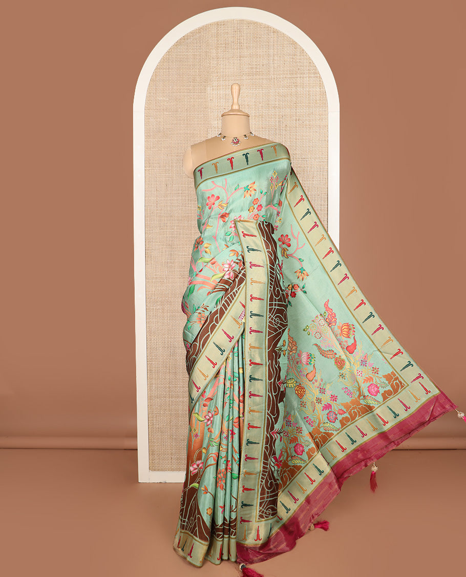 Pastel green colorful floral vine printed dola silk saree, muniya border, and tropical floral printed pallu