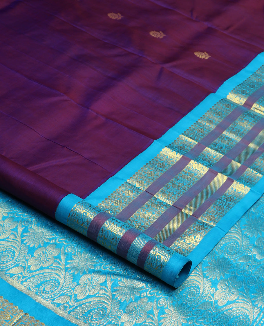 Purple zari buttas Kanchipuram silk saree, contrast one-sided korvai border of thilakam mokku, mayil, and rudraksham designs, and floral design pallu