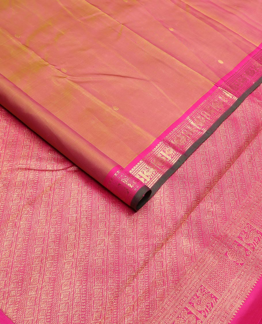 Orange zari buttas Kanchipuram silk saree, contrast border of thilakam mokku, maan, and mayil designs, and intricate pallu