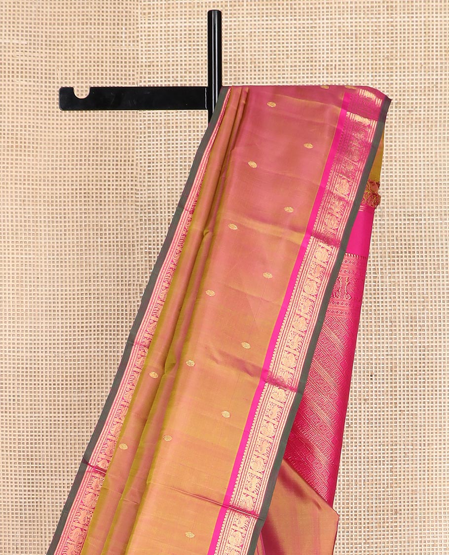 Orange zari buttas Kanchipuram silk saree, contrast border of thilakam mokku, maan, and mayil designs, and intricate pallu