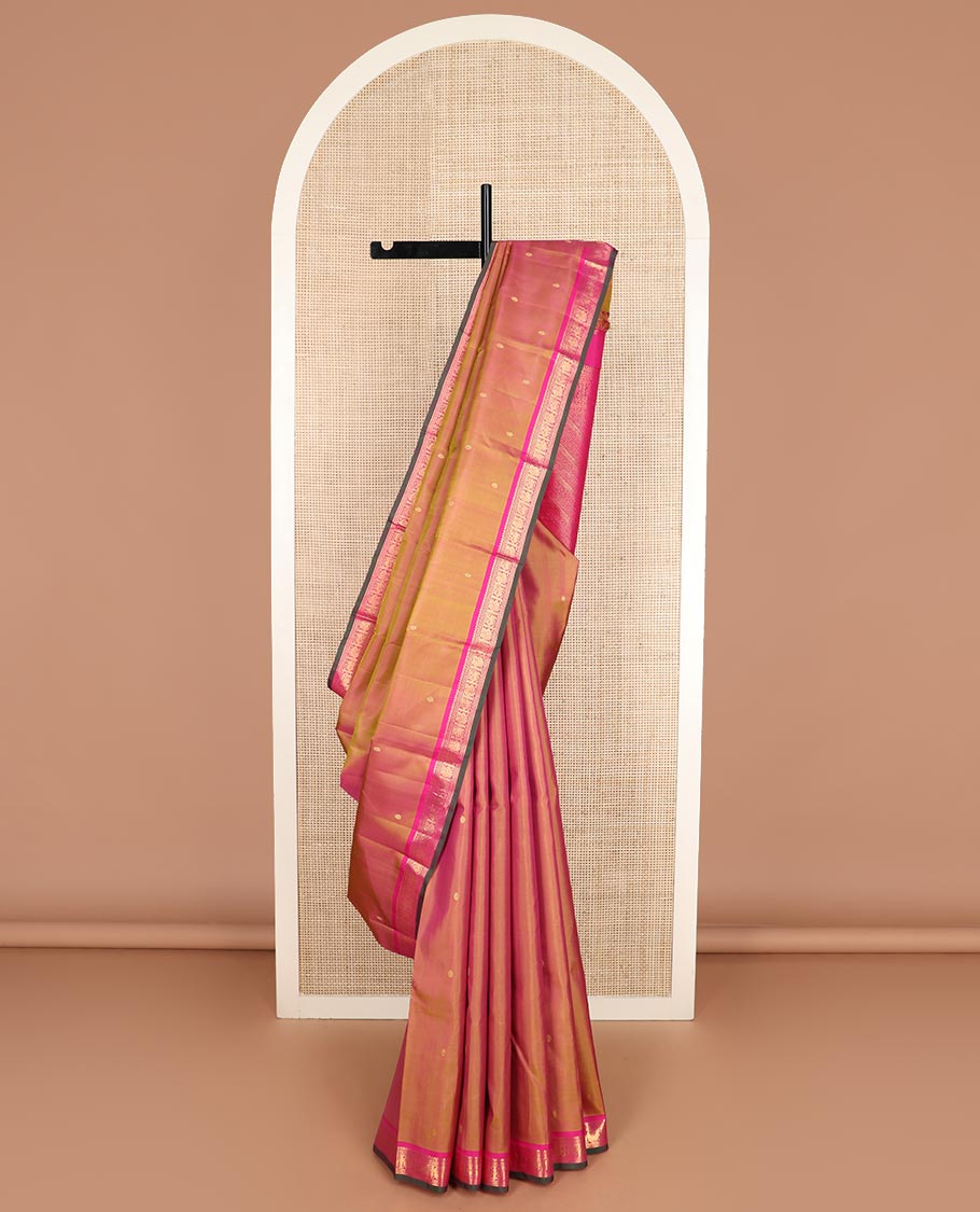 Orange zari buttas Kanchipuram silk saree, contrast border of thilakam mokku, maan, and mayil designs, and intricate pallu