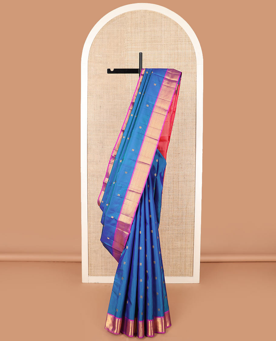 Blue mayil chakram buttas Kanchipuram silk saree, contrast border of thilakam mokku, banaras, muthu, and zari stripes, and mayil kann pallu