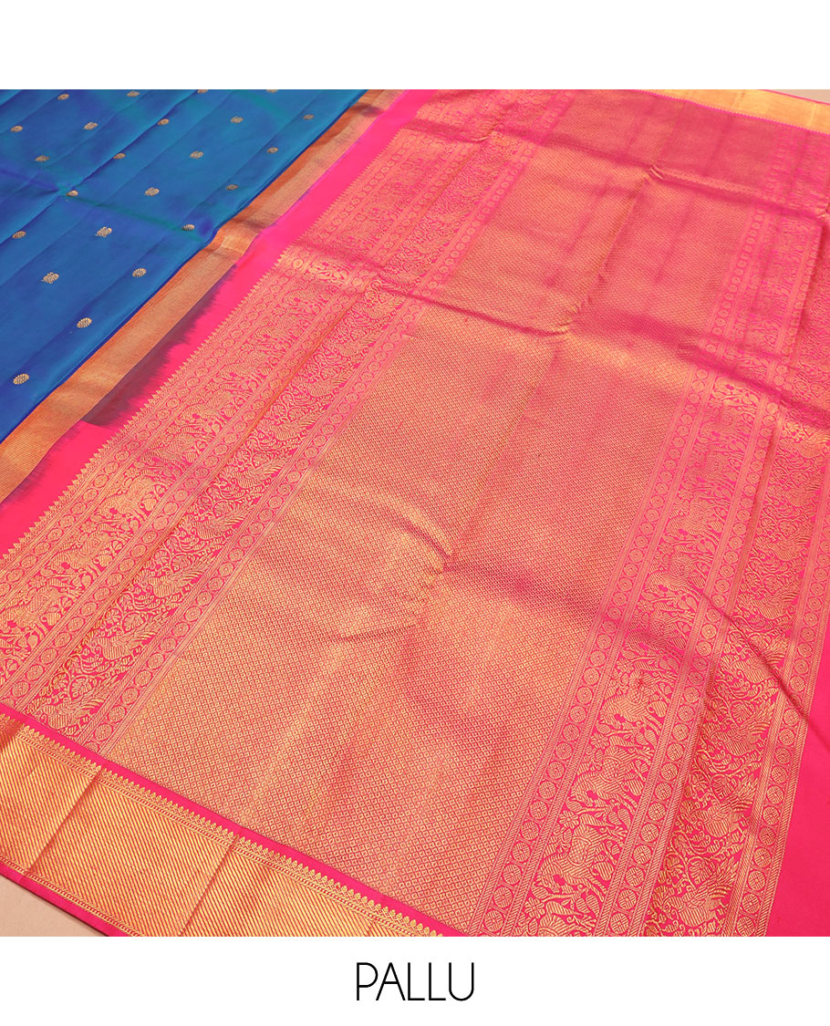 Blue mayil chakram buttas Kanchipuram silk saree, contrast border of thilakam mokku, banaras, muthu, and zari stripes, and mayil kann pallu