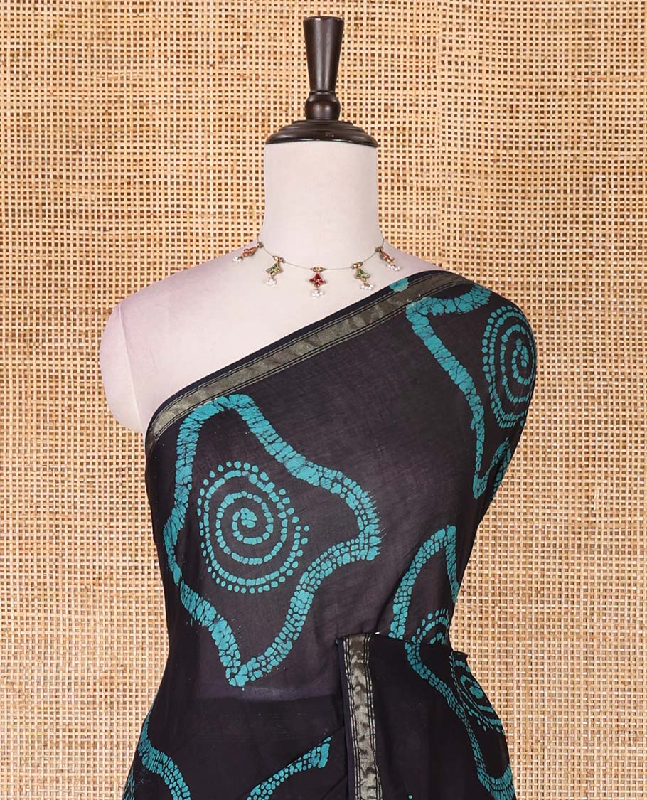 Black-blue batik geometric printed pure cotton saree, zari piping border, human figurines batik printed pallu, and a matching batik printed blouse