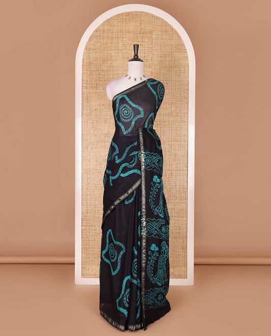 Black-blue batik geometric printed pure cotton saree, zari piping border, human figurines batik printed pallu, and a matching batik printed blouse