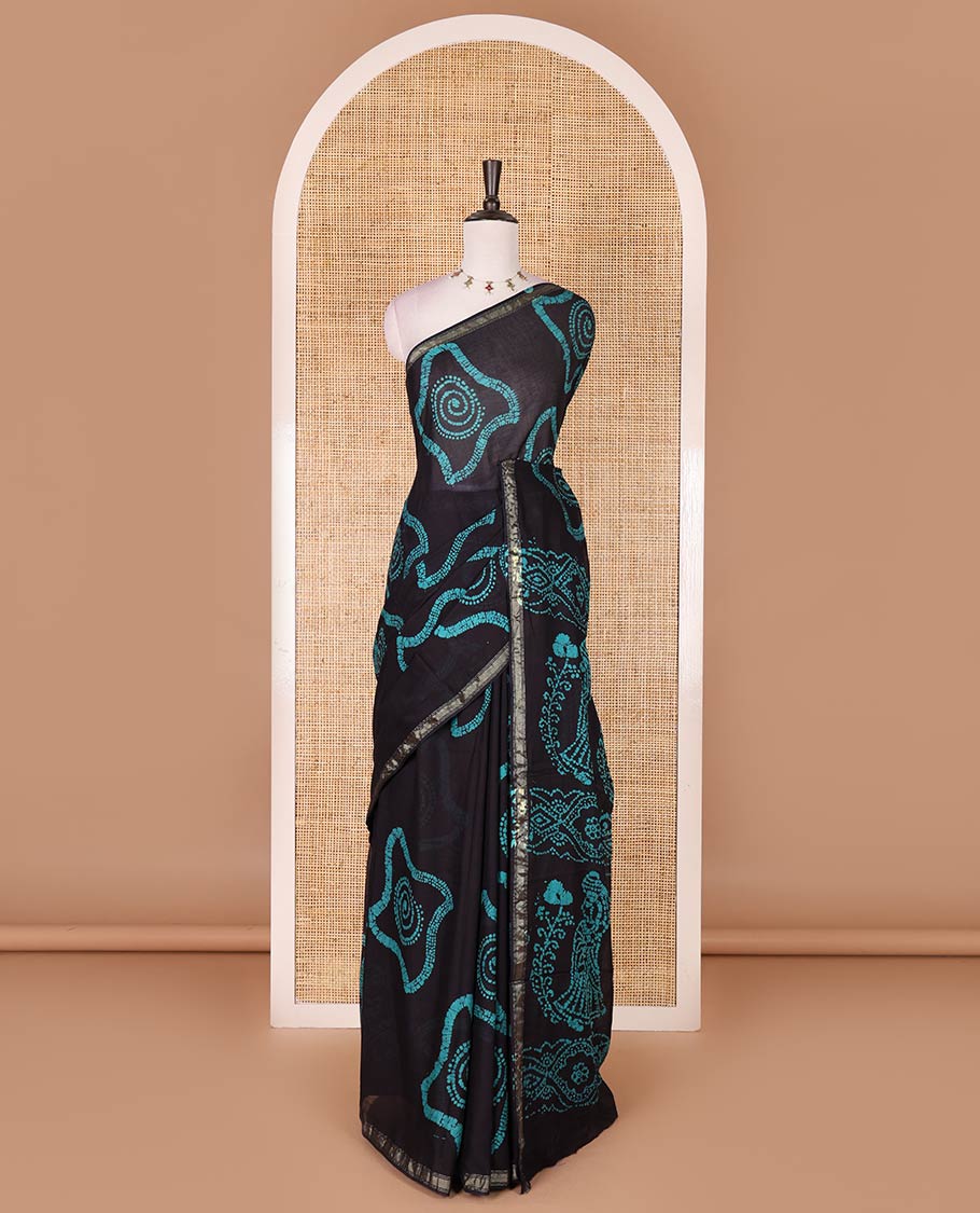 Black-blue batik geometric printed pure cotton saree, zari piping border, human figurines batik printed pallu, and a matching batik printed blouse